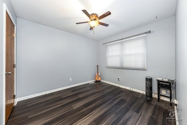 empty room featuring dark hardwood / wood-style flooring and ceiling fan