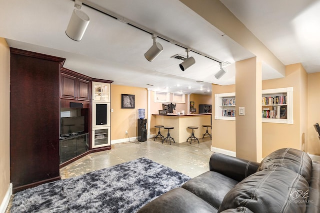 living room with rail lighting and bar area