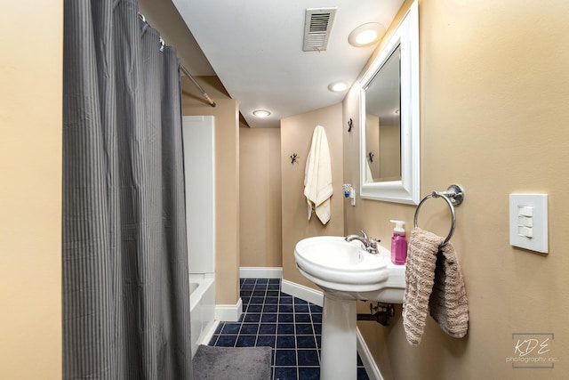 bathroom with sink, tile patterned floors, and shower / bath combo with shower curtain