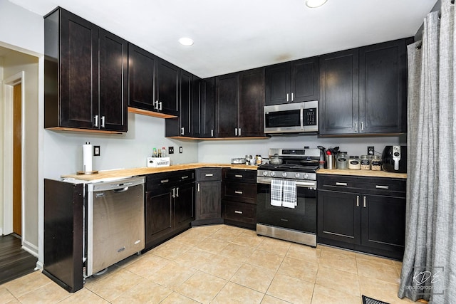 kitchen featuring stainless steel appliances and light tile patterned floors