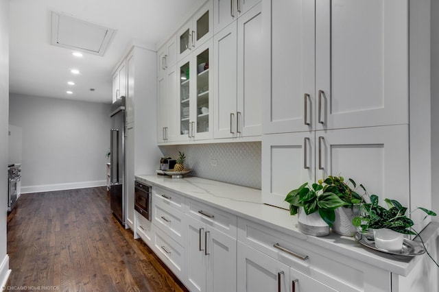 bar with built in microwave, recessed lighting, baseboards, decorative backsplash, and dark wood-style floors