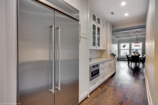 kitchen featuring white cabinets, glass insert cabinets, light stone counters, oven, and built in refrigerator