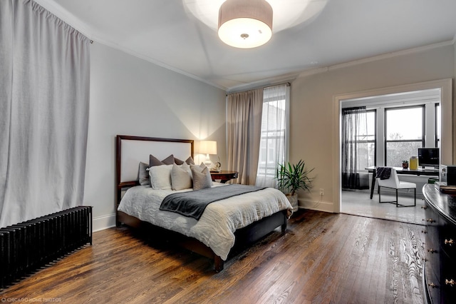 bedroom with crown molding, dark wood-type flooring, multiple windows, and radiator