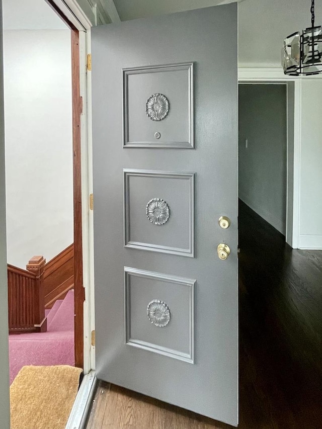 interior details with a notable chandelier and wood finished floors