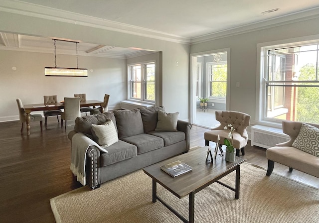 living room with radiator, visible vents, ornamental molding, wood finished floors, and baseboards