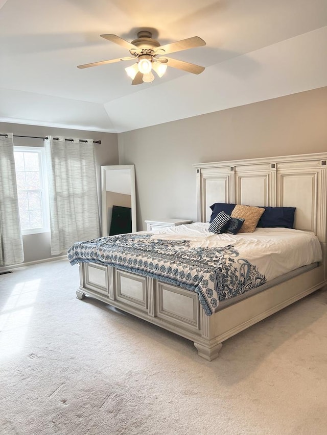 bedroom with lofted ceiling, light carpet, and ceiling fan