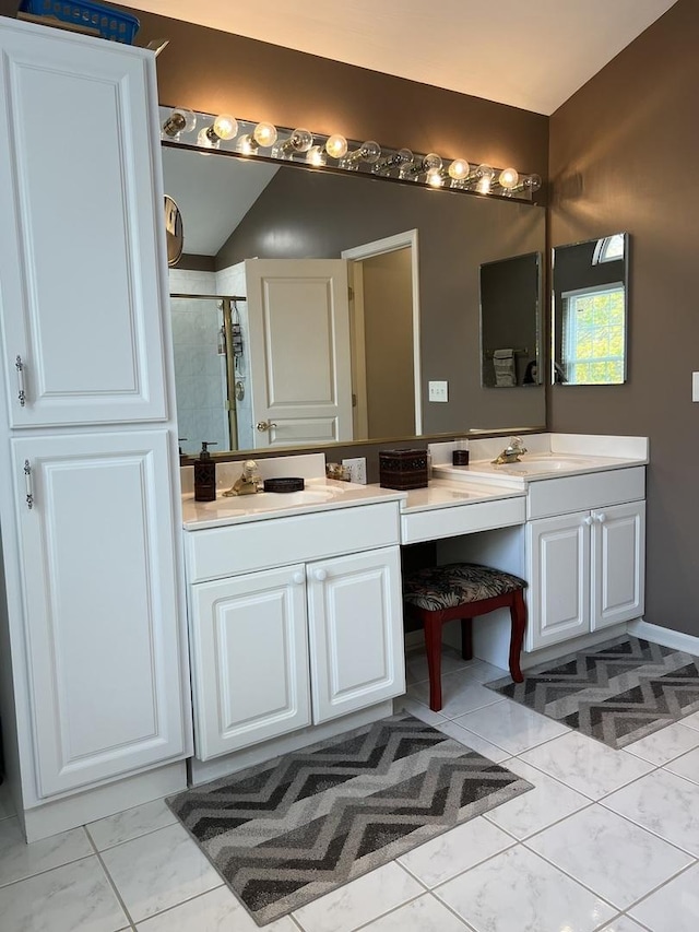 bathroom with vanity and a shower with shower door