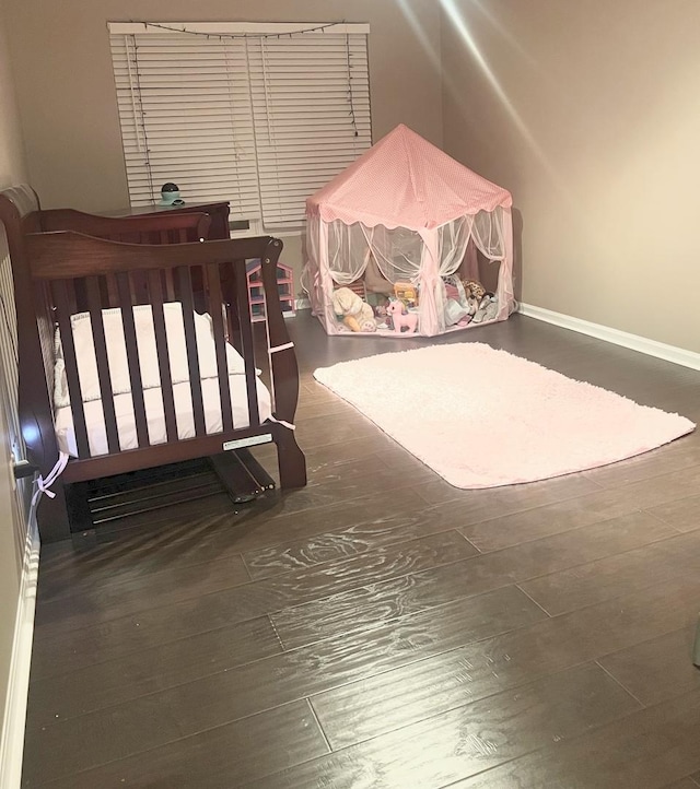 bedroom with dark hardwood / wood-style floors