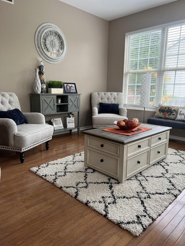 living area with hardwood / wood-style flooring