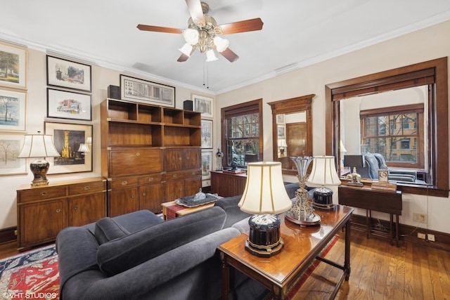 living room featuring hardwood / wood-style flooring, ceiling fan, and ornamental molding