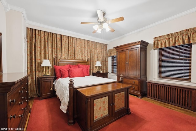 bedroom featuring dark carpet, radiator, crown molding, and ceiling fan