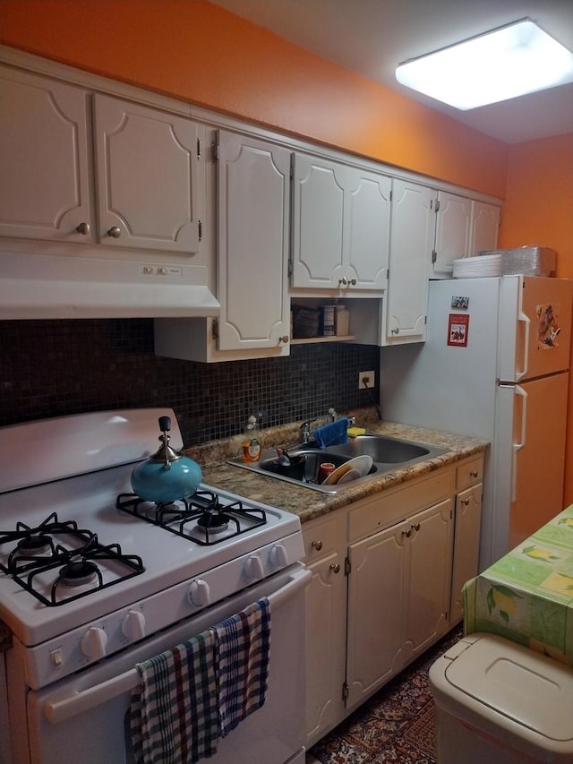 kitchen with white cabinets, decorative backsplash, white appliances, and sink