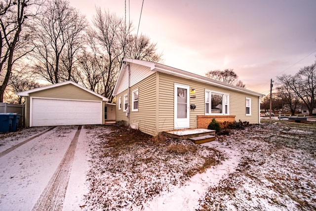 view of front of property featuring a garage and an outdoor structure