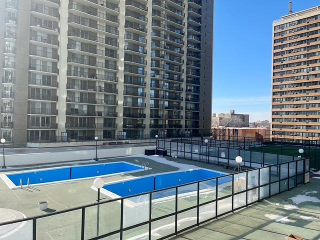 view of pool featuring tennis court