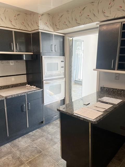 kitchen with light tile patterned floors and white appliances