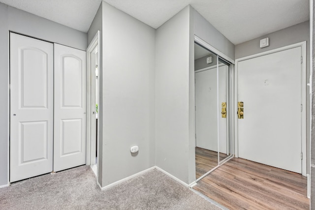 interior space featuring a textured ceiling and hardwood / wood-style flooring