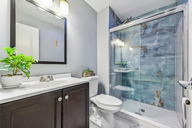 bathroom featuring an enclosed shower, vanity, and toilet