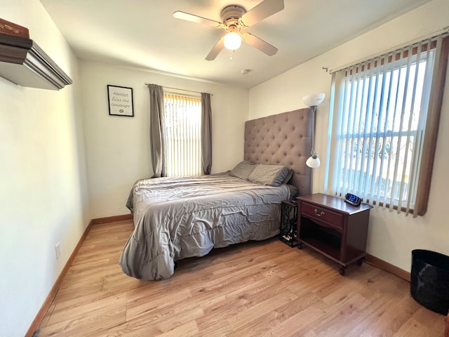 bedroom with light hardwood / wood-style flooring and ceiling fan