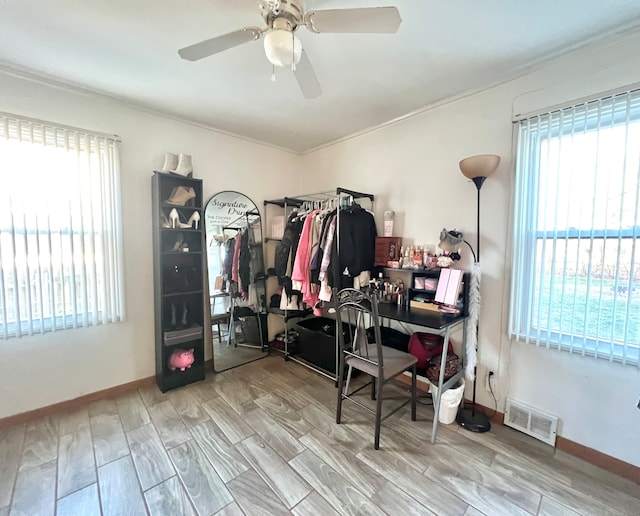 interior space with light hardwood / wood-style floors, ceiling fan, and ornamental molding