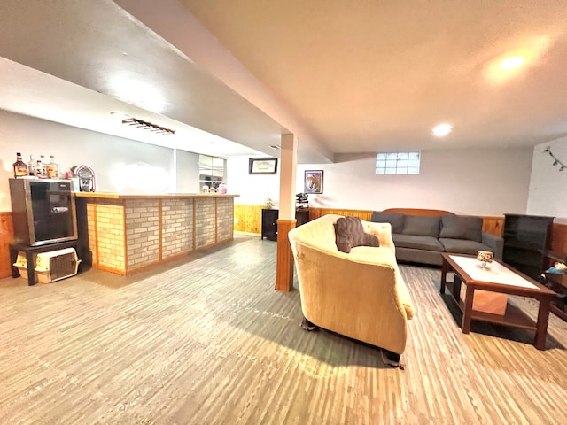 living room featuring wood-type flooring and bar area