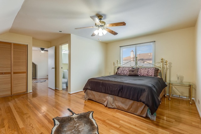 bedroom featuring light hardwood / wood-style flooring, ceiling fan, and ensuite bathroom