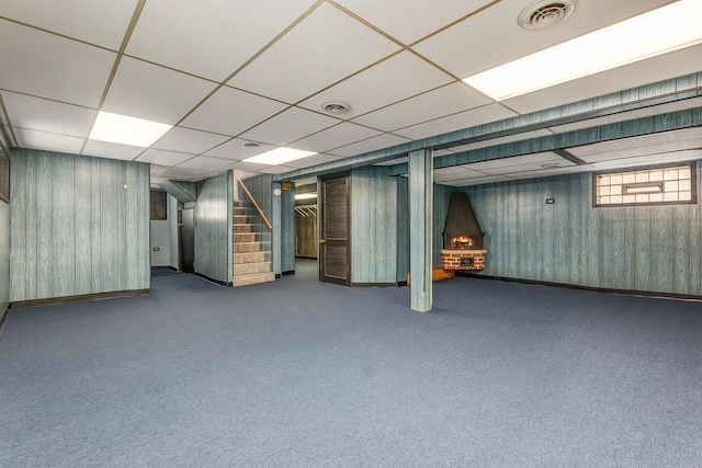 basement featuring carpet floors and a paneled ceiling