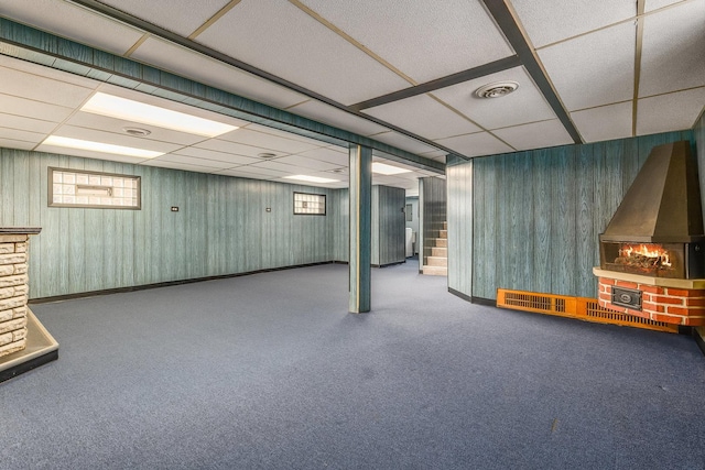 basement featuring a drop ceiling and carpet