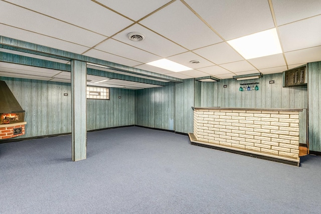 basement with a drop ceiling and carpet floors