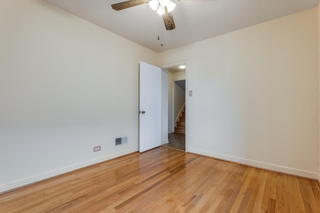 spare room with ceiling fan and light wood-type flooring