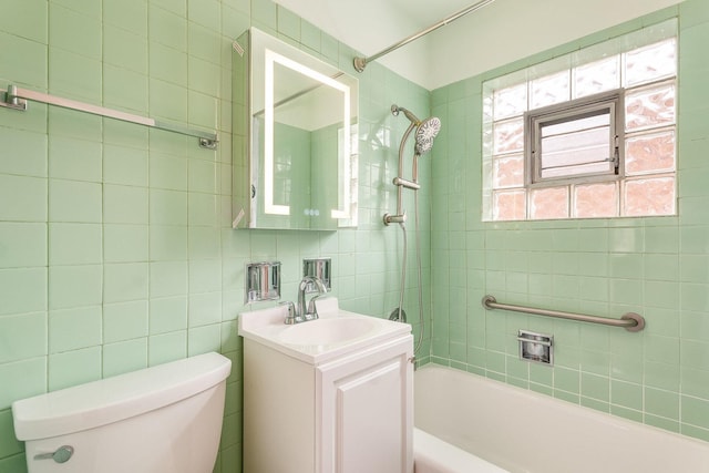 full bathroom with tiled shower / bath combo, vanity, tile walls, and toilet