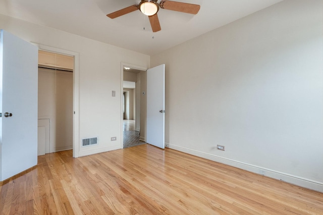 unfurnished bedroom featuring light hardwood / wood-style floors, a closet, and ceiling fan