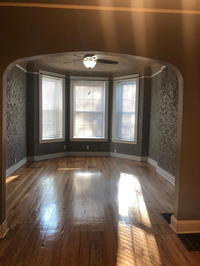 spare room featuring dark hardwood / wood-style floors and ceiling fan