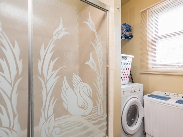 laundry area with separate washer and dryer and radiator heating unit