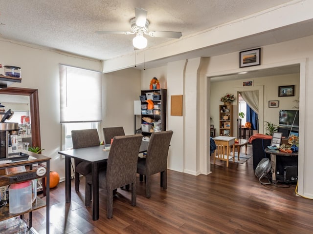 dining area with a textured ceiling, dark hardwood / wood-style floors, and ceiling fan