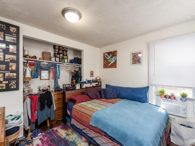 bedroom with a textured ceiling and a closet