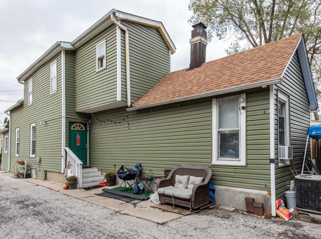 back of house with cooling unit