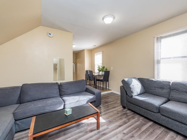 living room featuring hardwood / wood-style floors and vaulted ceiling