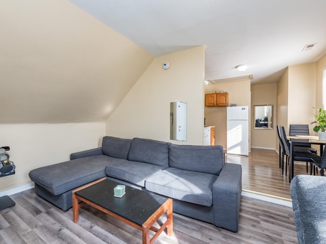 living room with vaulted ceiling and light hardwood / wood-style flooring