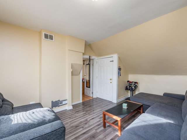 living room with lofted ceiling and hardwood / wood-style flooring