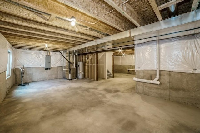 basement with electric water heater, electric panel, and heating unit