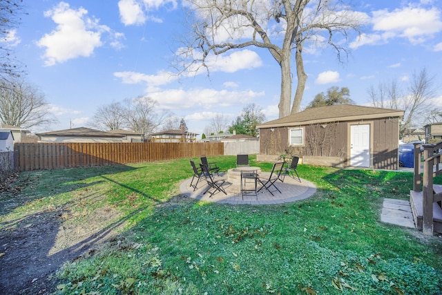 view of yard featuring a patio area, a storage unit, and an outdoor fire pit