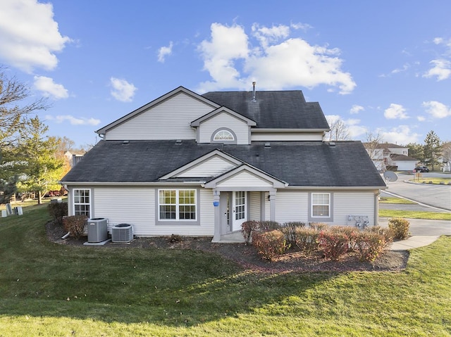 view of front of home featuring a front lawn and central AC