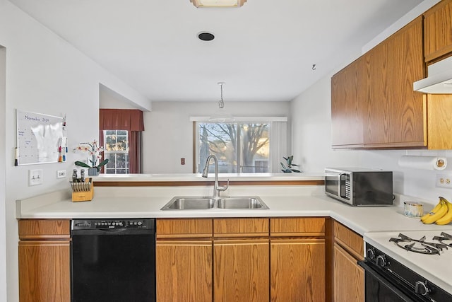 kitchen with dishwasher, sink, range hood, kitchen peninsula, and decorative light fixtures