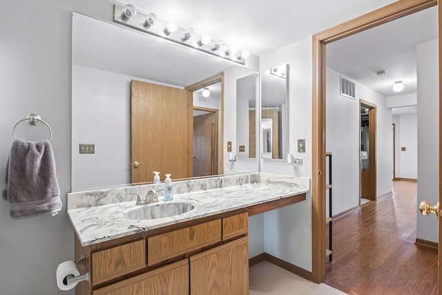 bathroom with hardwood / wood-style flooring and vanity