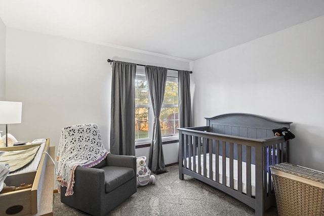 carpeted bedroom with a nursery area