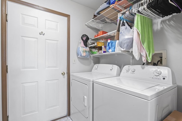 clothes washing area with washer and clothes dryer