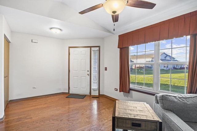 foyer entrance featuring ceiling fan, light hardwood / wood-style flooring, and lofted ceiling