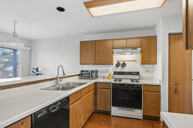 kitchen featuring white range, sink, decorative light fixtures, black dishwasher, and dark hardwood / wood-style floors