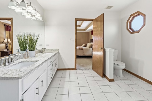 bathroom with tile patterned flooring, vanity, and toilet