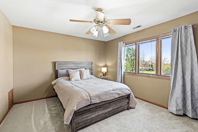 bedroom with ceiling fan and light carpet